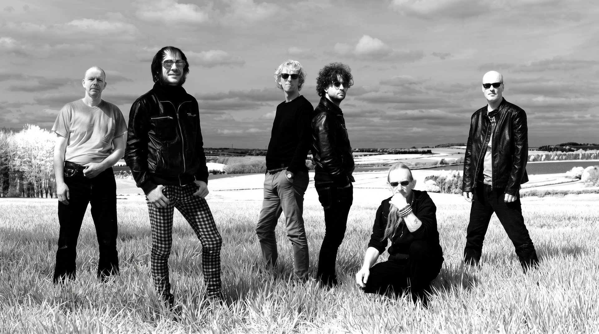ZAPPATiKA band members standing in a field on the U.K. tour, black and white