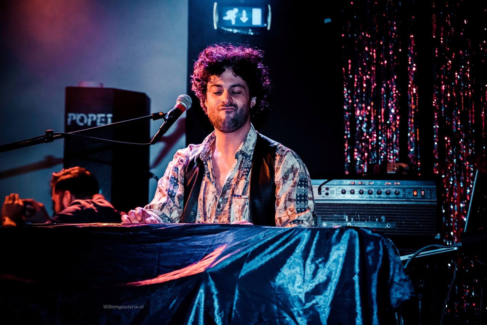 Osman Meyredi playing keyboards on stage in Eindhoven